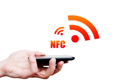Hand holding smartphone with NFC technology - near field communication payment methodの写真素材