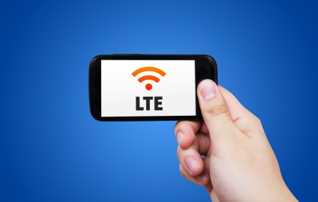 LTE high speed mobile internet connection. Hand holding cell with streaming dataの写真素材