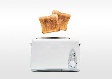 Jumping toasts. Preparing breakfast in modern toasterの写真素材