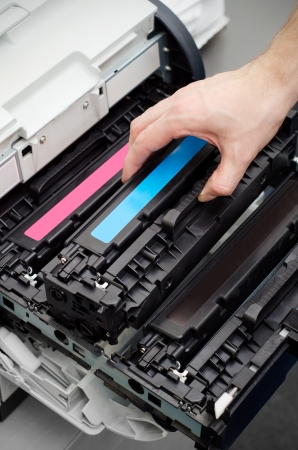 Man puts toner in the printerの写真素材