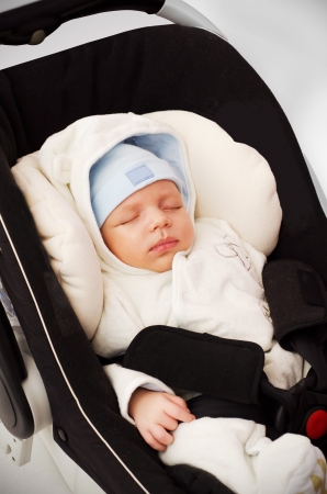 Little baby boy sleeping in car seatの写真素材