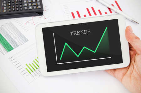Businessman working with tablet pc. Report charts in backgroundの写真素材