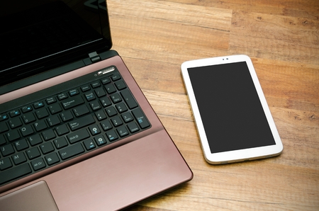 Cell phone and tablet with blank display od wooden backgroundの写真素材