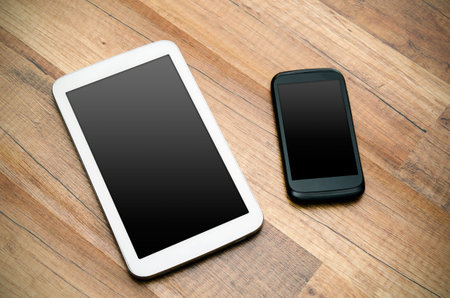 Cell phone and tablet with blank display od wooden backgroundの写真素材