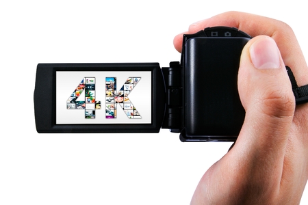 Hand holding Ultra High Definition camcorder isolated on whiteの写真素材