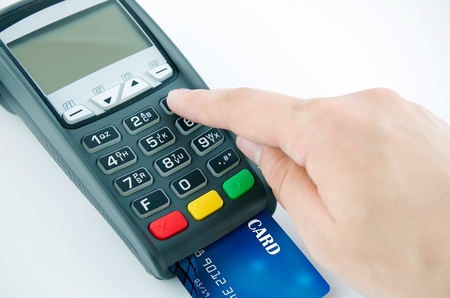 Man using payment terminal keypad, enter personal identyfication numberの写真素材