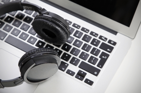 Close up of audio headset on laptop. Wireless headphonesの写真素材