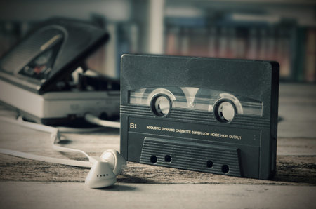 Old casette tape player. Retro style photo on wooden background