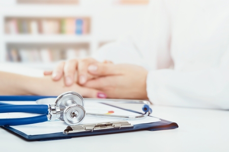 Doctor and patient in office. doctor medical patient stethoscope health care consulting hand conceptの写真素材