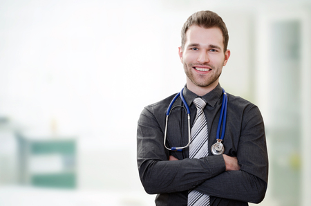 Handsome young doctor in office. Healthcare and medicine conceptの写真素材