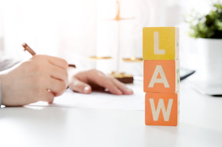 LAW word from toy blocks. Lawyer working in background. lawyer law justice judge scales courtroom...