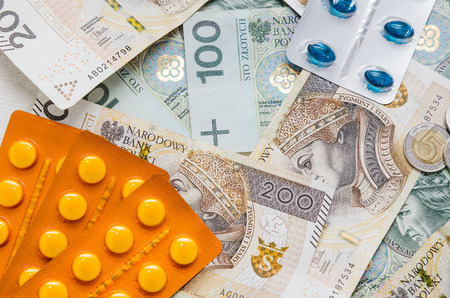 Pills and polish zloty bills. medicine pills health cost polish money zloty pln conceptの写真素材