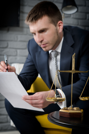 Weight scale of justice, lawyer in background. lawyer document agreement attorney scales authority background balance conceptの写真素材