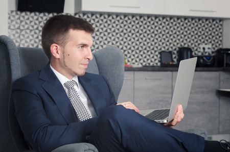 Businessman working in home with computer in the morningの写真素材