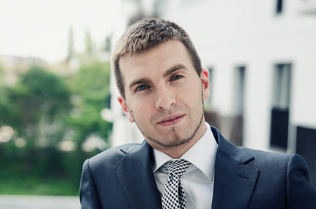 Relaxed businessman standing on balcony of his apartment. businessman outdoor friendly caucasian...