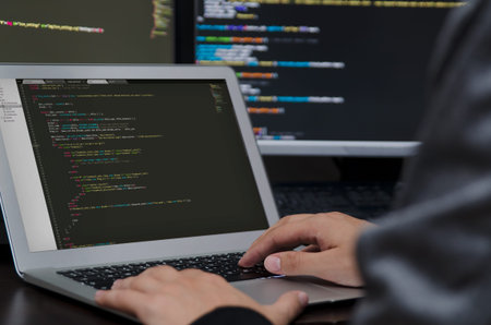 Hacker working on a code. Programming code on screen. Internet crime concept
