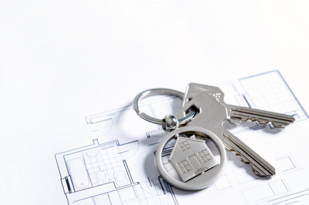 House key on a house shaped pendant. Real estate agent business card template