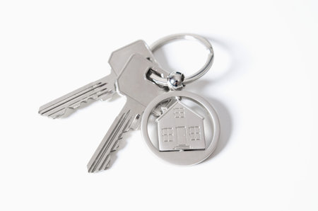 House key on a house shaped pendant. Real estate agent business card template