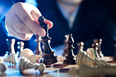 Chess financial business strategy concept. Team leader holding chess piece.の写真素材