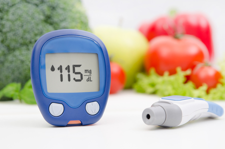 Glucometer and lancelet on vegetables backgroundの写真素材