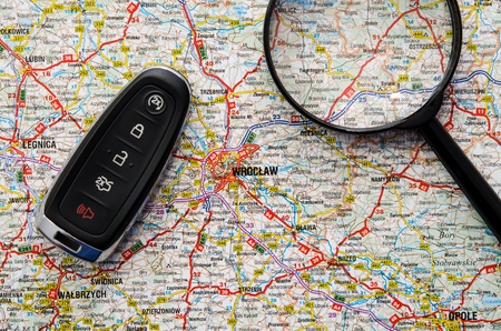 Set of car keys and magnify over a map. Travel conceptの写真素材
