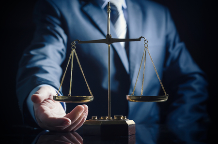 Weight scale of justice, lawyer in background. justice law lawyer attorney scale weight court authority conceptの写真素材