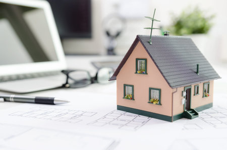 House model on desk, mortgage, investment or house building concept