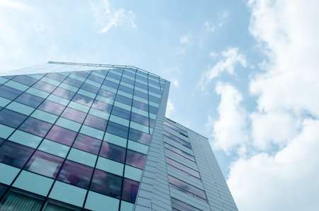 Low angle view of skyscraper. Urban abstract - blue glass wall for background.