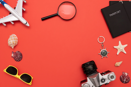Summer Travel accessories on red background. Travel planning top view conceptの写真素材