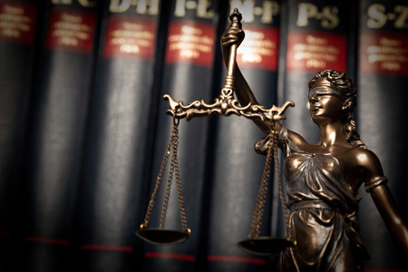Lady justice, themis, statue of justice on books background. Law concept with justice figurine in...