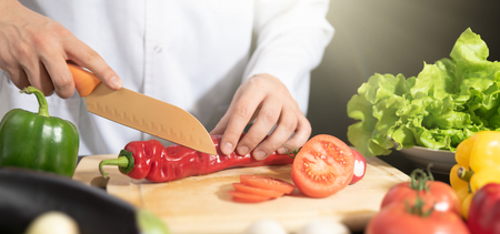 Chef prepares fresh vegetables. Cooking, healthy nutrition conceptの写真素材