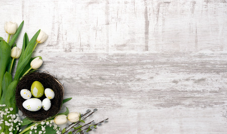 Easter eggs and spring flowers background. Top view with copy space.の写真素材