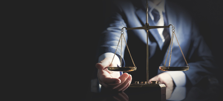 Weight scale of justice, lawyer or attorney concept. Unrecognizable person studio shot, copy space web banner backgroundの写真素材