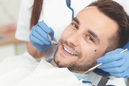 Young man at the dentist. Dental care, treatment of teeth, taking care of teethの写真素材