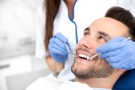 Man having teeth examined at dentists. Overview of dental caries preventionの写真素材