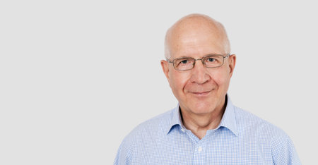 Portrait of senior man with glasses. Studio shot with copy space