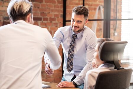 Men shaking hands while working in team. Business contract or agreement sign conceptの写真素材