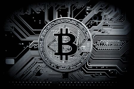 Bitcoin cryptocurrency, virtual money, blockchain technology. Coin on circuit board as microprocessor concept.の写真素材