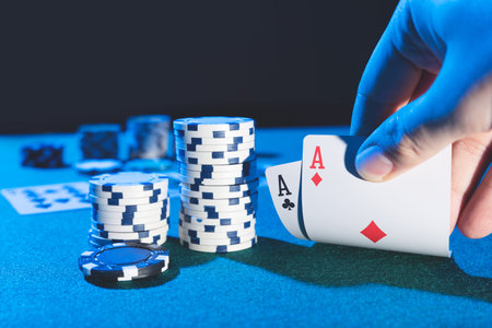 Man plays poker in the casino. Holding cards in hand, gambling concept