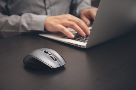 Man working with laptop in office. Business employer at work