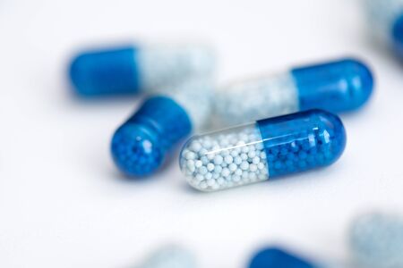 Blue capsule, pills on white background. Health care, medical, pharmacy conceptの写真素材