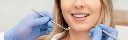 Young woman in stomatology clinic. Dental health, teeth whitening concept.の写真素材