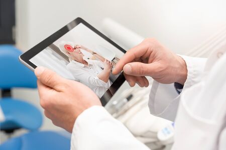 Doctor and senior woman patient medical consultation. Telemedicine, remote health care concept.の写真素材