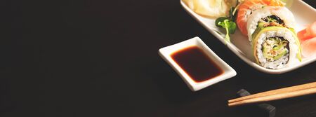 Sushi roll set on plate. Japanese Asian traditional food front view. Web banner background with copy spaceの写真素材