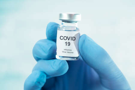 Doctor holding Covid-19 vaccine bottle. Influenza, flu, corona virus vaccineの写真素材