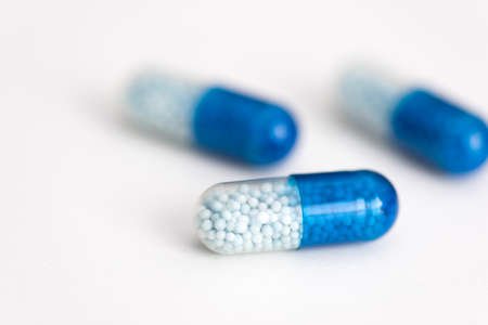 Blue capsule, pills on white background. Health care, medical, pharmacy conceptの写真素材