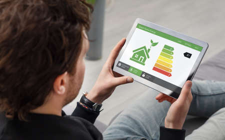 Energy efficiency mobile app on screen. Ecology, eco house conceptの写真素材
