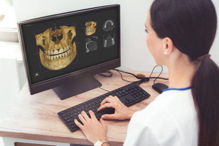 Woman dentist is looking at a photo of the 3D tomograph. Treatment, protection, health care for...