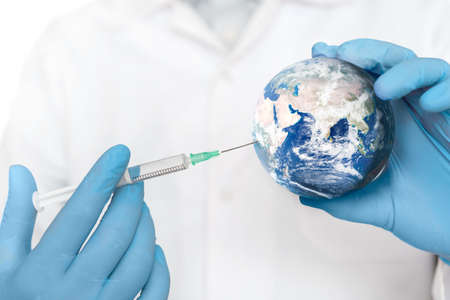 Global vaccine against the virus. Man injects the vaccine into the globe. Elements of this image furnished by .の写真素材