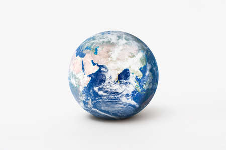 World environment day concept. Earth globe model with shadow on white background.の写真素材